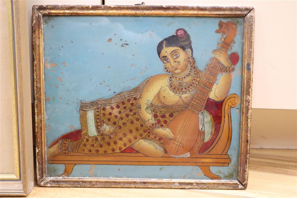 19th century Indian School, reverse painted and gilt glass, Woman playing a sitar, 25 x 30cm